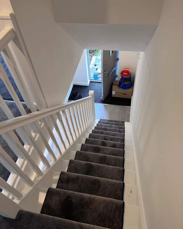 Grey flecked carpet, hand made stair runner with contrasting peacock blue edging. 
Ground floor prepared and Karndean Opus LVT flooring laid throughout this stunning new build at Odd Down, Bath.
